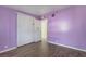 This bedroom has purple walls, closet and wood-look floors at 1520 Teton St, Las Vegas, NV 89101