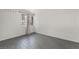 This bedroom has white brick walls, gray wood-look floors, and a window with bars at 1520 Teton St, Las Vegas, NV 89101