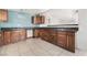 View of the kitchen featuring dark countertops, wooden cabinets, and light blue walls at 1520 Teton St, Las Vegas, NV 89101