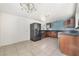 Kitchen with tiled floors, dark cabinets, and stainless steel refrigerator at 1520 Teton St, Las Vegas, NV 89101
