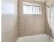 Close up of updated shower with neutral toned tiles at 1520 Teton St, Las Vegas, NV 89101
