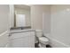 Clean bathroom featuring a vanity with a gray countertop, a toilet, and a shower-tub combo at 1713 Desert Path Ave, North Las Vegas, NV 89032