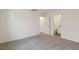 Cozy bedroom with plush carpeting and a view of an adjacent bathroom at 1713 Desert Path Ave, North Las Vegas, NV 89032