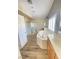 Bright bathroom features a soaking tub, walk-in shower, and double sink vanity with wood-look floors at 172 Tall Ruff Dr, Las Vegas, NV 89148