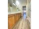 Long bathroom with wood cabinets, double sinks, separate shower and toilet room, designed for comfort and style at 172 Tall Ruff Dr, Las Vegas, NV 89148