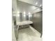 Modern-styled bathroom with double sinks and a decorative backsplash at 172 Tall Ruff Dr, Las Vegas, NV 89148
