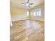 Bright bedroom features wood floors, ceiling fan, and natural light from two windows at 172 Tall Ruff Dr, Las Vegas, NV 89148
