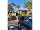 Gated community entrance with multiple palm trees and stone architectural details on a sunny day at 172 Tall Ruff Dr, Las Vegas, NV 89148