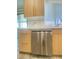 Modern kitchen with stainless steel dishwasher under a window and marble backsplash at 172 Tall Ruff Dr, Las Vegas, NV 89148