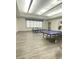 Large game room with modern flooring and ping pong tables by large window at 172 Tall Ruff Dr, Las Vegas, NV 89148