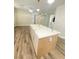 Spacious kitchen featuring an island with marble countertop, wood cabinets, and luxury vinyl plank flooring at 172 Tall Ruff Dr, Las Vegas, NV 89148