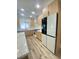 Well-lit kitchen featuring stainless steel appliances, light wood cabinets, and marble countertops and backsplash at 172 Tall Ruff Dr, Las Vegas, NV 89148