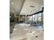 Bright lobby area with plush seating, a piano, and floor-to-ceiling windows at 172 Tall Ruff Dr, Las Vegas, NV 89148