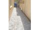 Exterior view of the stone-paved side yard with a trash receptacle at 172 Tall Ruff Dr, Las Vegas, NV 89148