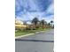 Street view showcasing well-maintained lawns, mature palm trees, and beautiful neighborhood homes at 172 Tall Ruff Dr, Las Vegas, NV 89148