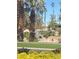 Picturesque waterfall feature surrounded by lush landscaping and mature palm trees at 172 Tall Ruff Dr, Las Vegas, NV 89148