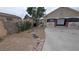 The backyard features a concrete patio and desert landscaping, creating an inviting space at 1910 Hoover St, North Las Vegas, NV 89030