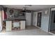 Finished bonus room with bar, tile floors, a mounted projector and decorations on the wall at 1910 Hoover St, North Las Vegas, NV 89030