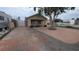 View of the home's front, with a mix of concrete and brick-paved driveway leading to the house at 1910 Hoover St, North Las Vegas, NV 89030