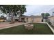 Charming home featuring a well-maintained front yard and a lovely decorative fire pit at 1910 Hoover St, North Las Vegas, NV 89030