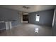 Inviting living room featuring neutral walls, ceramic tile flooring, and modern lighting fixtures at 1910 Hoover St, North Las Vegas, NV 89030