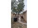 Side yard with gravel, a walkway to the back and an air conditioning unit on the side of the house at 1910 Hoover St, North Las Vegas, NV 89030