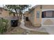 Side yard with gravel, a walkway to the back and an air conditioning unit on the side of the house at 1910 Hoover St, North Las Vegas, NV 89030