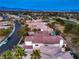 High-angle view of a home with a red tile roof, complemented by lush greenery and a distant cityscape at 1912 Glenview Dr, Las Vegas, NV 89134