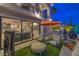 Expansive backyard with a seamless blend of indoor and outdoor living, featuring a patio, pool, and lush landscaping at 1912 Glenview Dr, Las Vegas, NV 89134