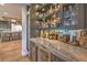 Elegant bar area with marble countertops, open shelving with glassware, and refrigerated beverage storage at 1912 Glenview Dr, Las Vegas, NV 89134