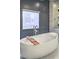 Stylish bathroom with a modern freestanding bathtub, wood caddy, and marble accents at 1912 Glenview Dr, Las Vegas, NV 89134