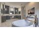 Well-appointed bathroom with freestanding tub, marble countertops, dual vanities, and a TV at 1912 Glenview Dr, Las Vegas, NV 89134
