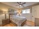 Comfortable bedroom with a tray ceiling, ceiling fan, stylish lighting, and hardwood floors at 1912 Glenview Dr, Las Vegas, NV 89134