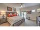 Comfortable bedroom featuring a king-size bed, ceiling fan, television, and access to the outdoor patio at 1912 Glenview Dr, Las Vegas, NV 89134