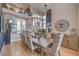 Open concept dining area featuring modern decor, a large table, and glass-enclosed staircase at 1912 Glenview Dr, Las Vegas, NV 89134
