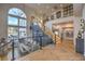 Open dining room and staircase showcasing herringbone floors, large windows, and modern railings at 1912 Glenview Dr, Las Vegas, NV 89134