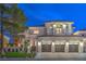Magnificent two-story home with a three-car garage and a balcony, illuminated against the night sky at 1912 Glenview Dr, Las Vegas, NV 89134