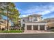 Stunning two-story home featuring a well-manicured lawn, mature trees, and a three-car garage, under a sunny blue sky at 1912 Glenview Dr, Las Vegas, NV 89134