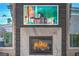 Close-up of a modern fireplace with marble surround and sleek dark wood paneling at 1912 Glenview Dr, Las Vegas, NV 89134