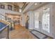 Grand foyer with high ceilings, decorative glass doors, herringbone wood floors, and a staircase with glass railings at 1912 Glenview Dr, Las Vegas, NV 89134