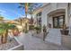 Inviting front entrance featuring tiled steps, potted plants, and outdoor seating surrounded by lush landscaping at 1912 Glenview Dr, Las Vegas, NV 89134