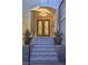 Elegant front entrance with decorative tiled steps, potted plants, and a welcoming arched doorway at 1912 Glenview Dr, Las Vegas, NV 89134