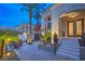 Grand front entrance with tiled steps, seating, and lush greenery, creating an inviting outdoor space at 1912 Glenview Dr, Las Vegas, NV 89134