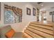 Hallway with illuminated stairs, modern art, and hardwood floors leading to other rooms in the house at 1912 Glenview Dr, Las Vegas, NV 89134