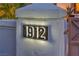 Close-up of the illuminated house number 