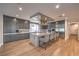 Modern kitchen features custom gray cabinetry, herringbone backsplash, stainless steel appliances, and a large center island with seating at 1912 Glenview Dr, Las Vegas, NV 89134