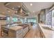 Large kitchen island with marble countertops, Wolf appliances, and easy access to outdoor living space at 1912 Glenview Dr, Las Vegas, NV 89134