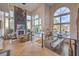 Bright living area with herringbone floors, floor-to-ceiling windows, fireplace, and views of the pool at 1912 Glenview Dr, Las Vegas, NV 89134
