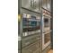 Contemporary kitchen with Wolf stainless steel oven and built in microwave and custom gray cabinetry at 1912 Glenview Dr, Las Vegas, NV 89134