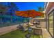 Cozy outdoor living area with comfortable seating, a television, and manicured turf for a relaxing experience at 1912 Glenview Dr, Las Vegas, NV 89134